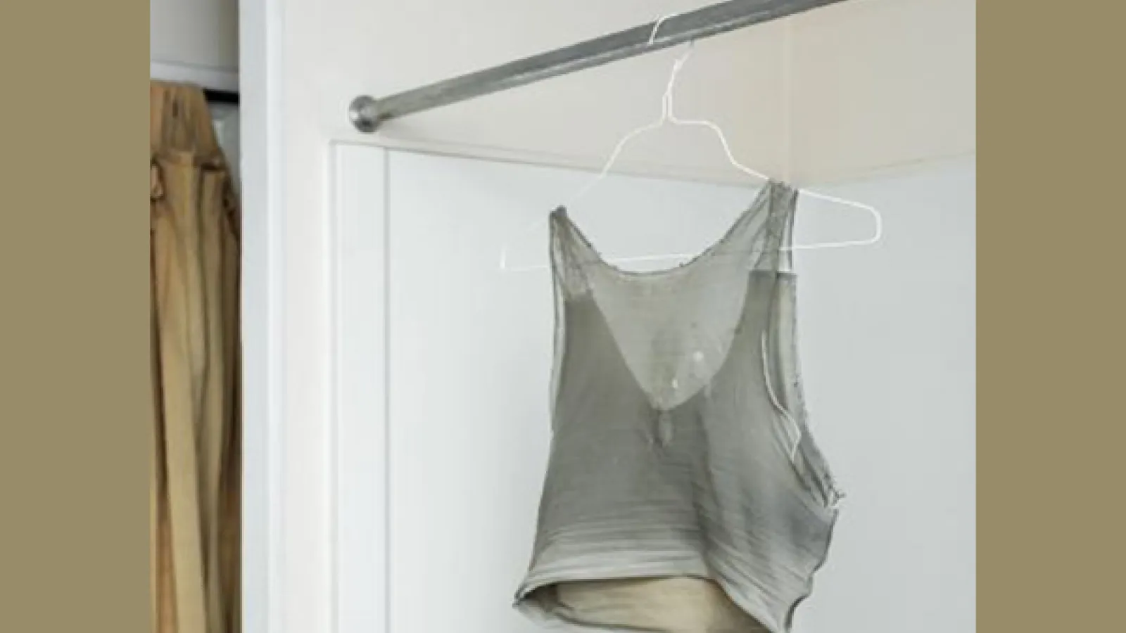 Binder, by Elle Pérez (2015); a wet compression chest binder hanging from a shower rod