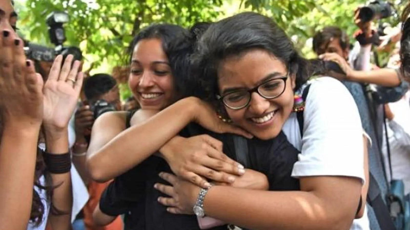 Three people hugging