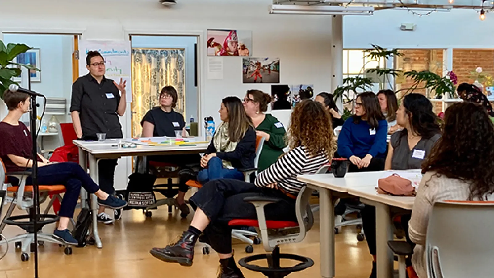 Person speaking to colleagues at FREE Center event 