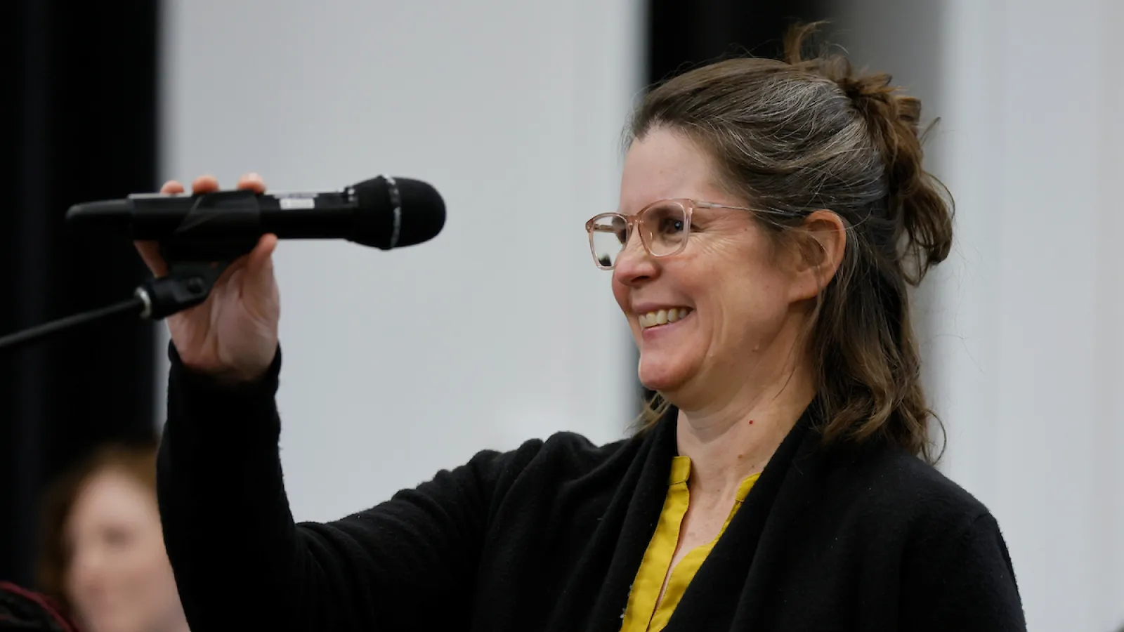 Alison Norris holding microphone
