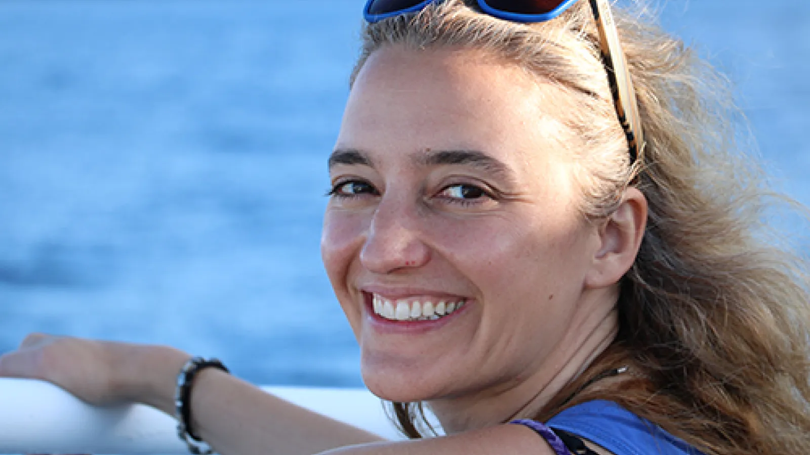 WGSS Alum Dr. Sara Riva smiling on a boat