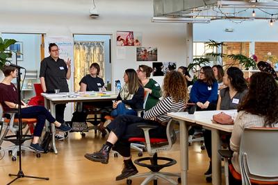 Person speaking to colleagues at FREE Center event 