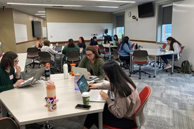 Students working on computers at tables