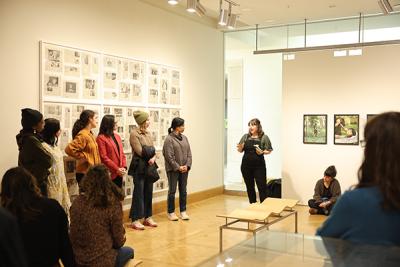 Librarian leading discussion at art exhibit