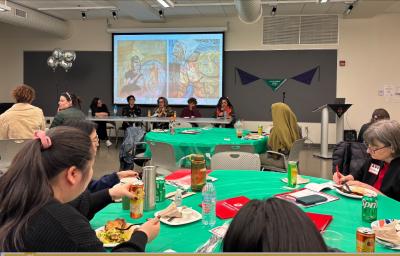 People eating lunch and watching a presentation