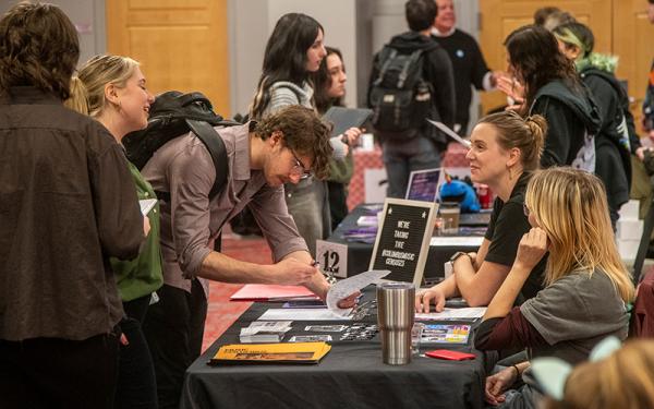 Students talking to employers at career fair