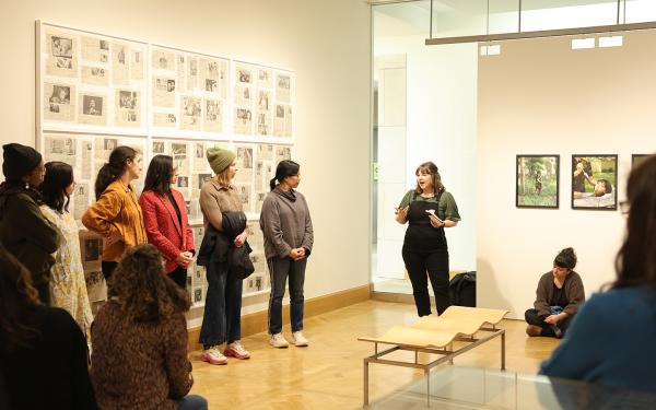Librarian leading discussion at art exhibit