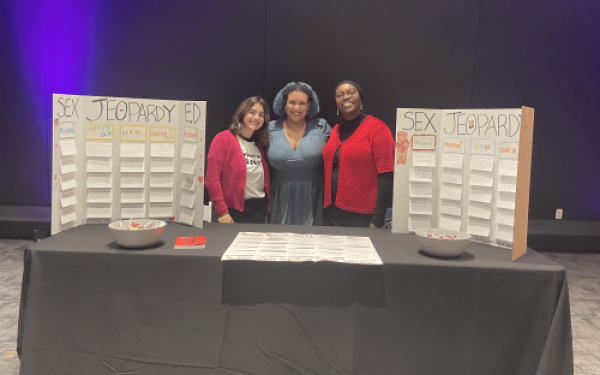 Group of graduate students hosting a table at COSI event