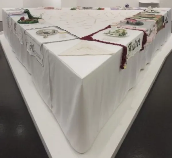 A table set with unique and colorful dinnerware and place mats with names on each.