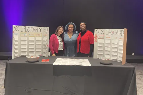 Group of graduate students hosting a table at COSI event