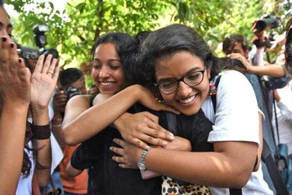 Three people hugging