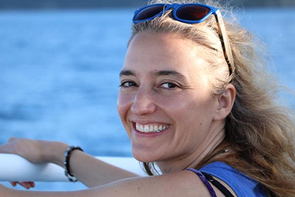 WGSS Alum Dr. Sara Riva smiling on a boat
