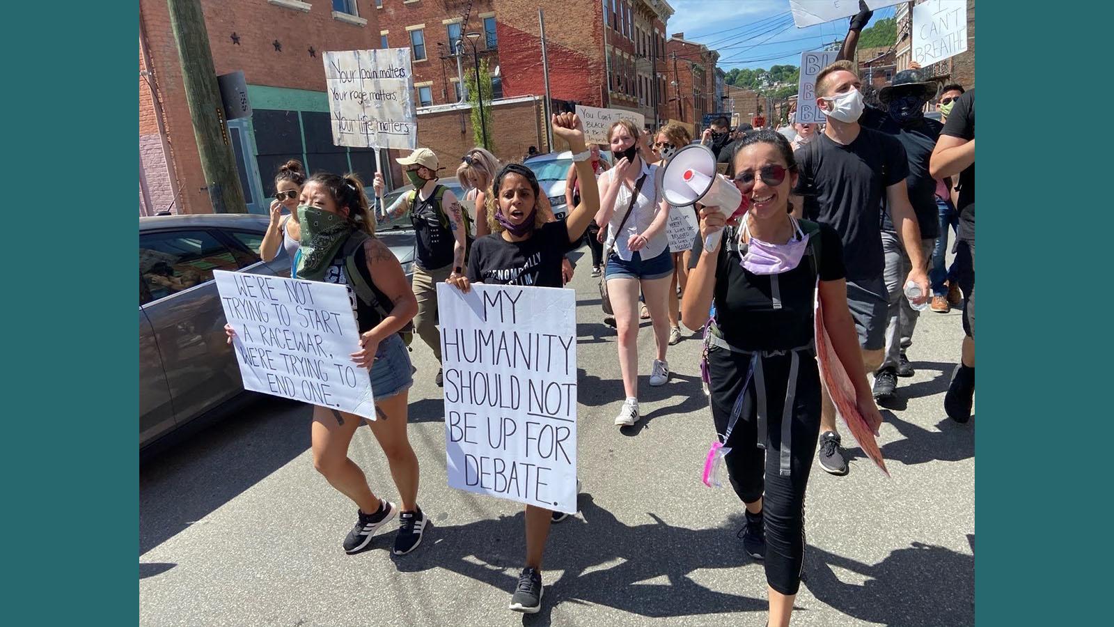 Black Lives Matter protesters marching and holding signs